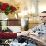 Hotel reception where guests are checking in to the hotel and receptionist is assisting them