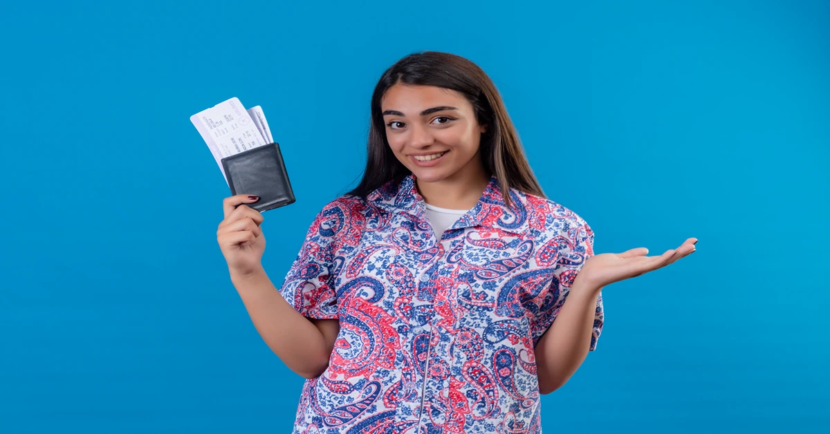 Beautiful woman standing with passport and air tickets