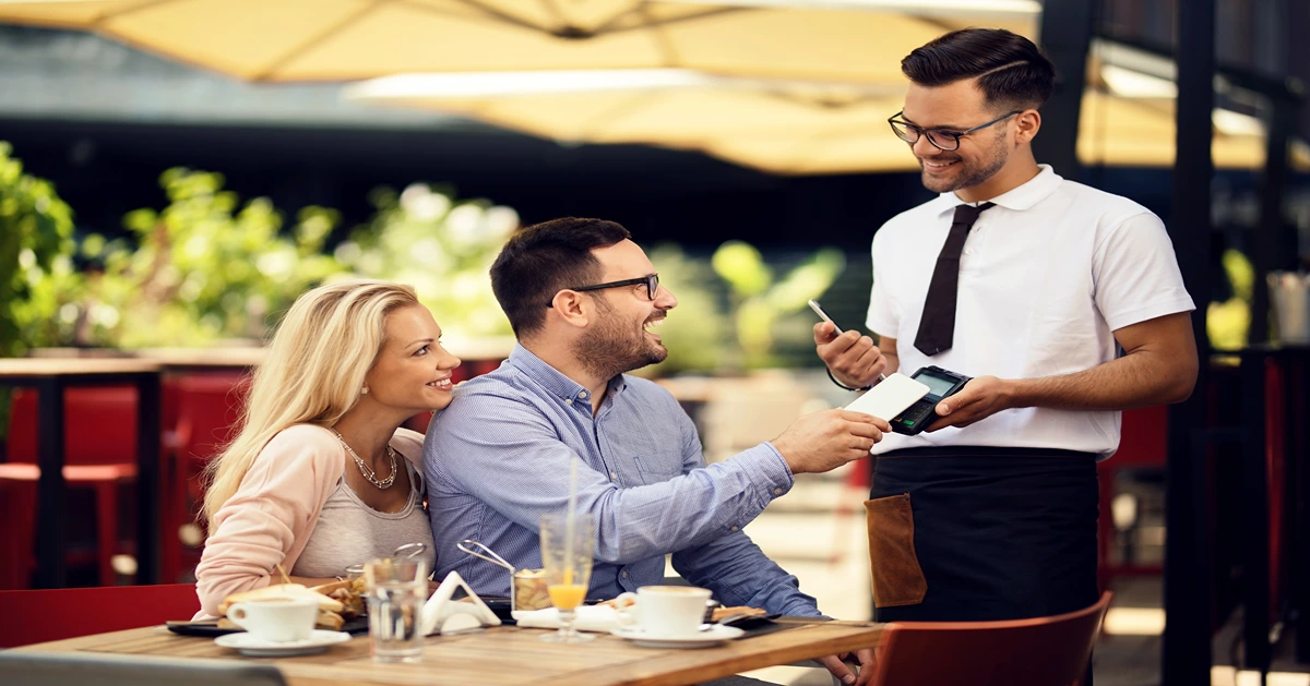 a couple paying food bill at restaurant